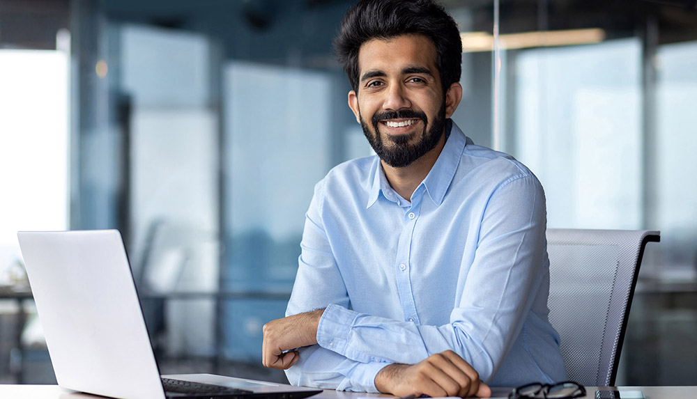 An MSA professional smiling in a modern office.