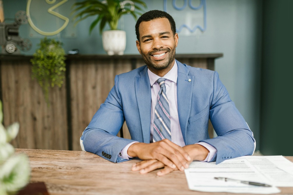 Professionally dressed individual seated at a desk in a modern office, symbolizing career readiness and leadership—key themes in the MIM vs. MBA decision.